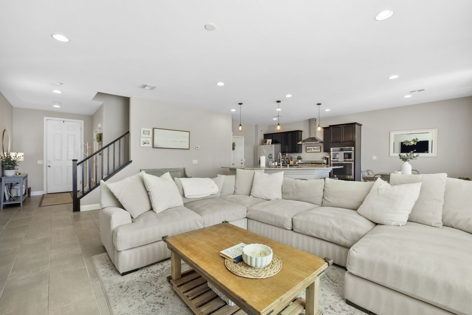 Living room, 14 feet 1 inch by 20 feet 5 inches, looking back to the foyer and stairs.