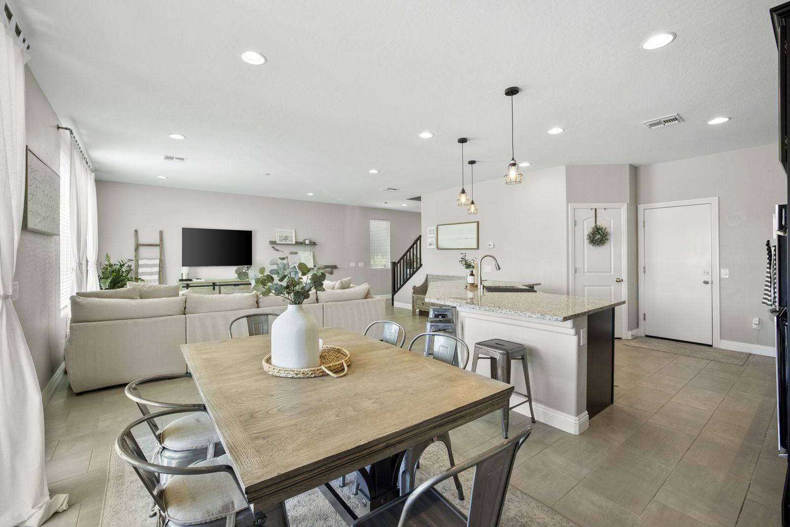 The dining area sits between the kitchen and the living room.