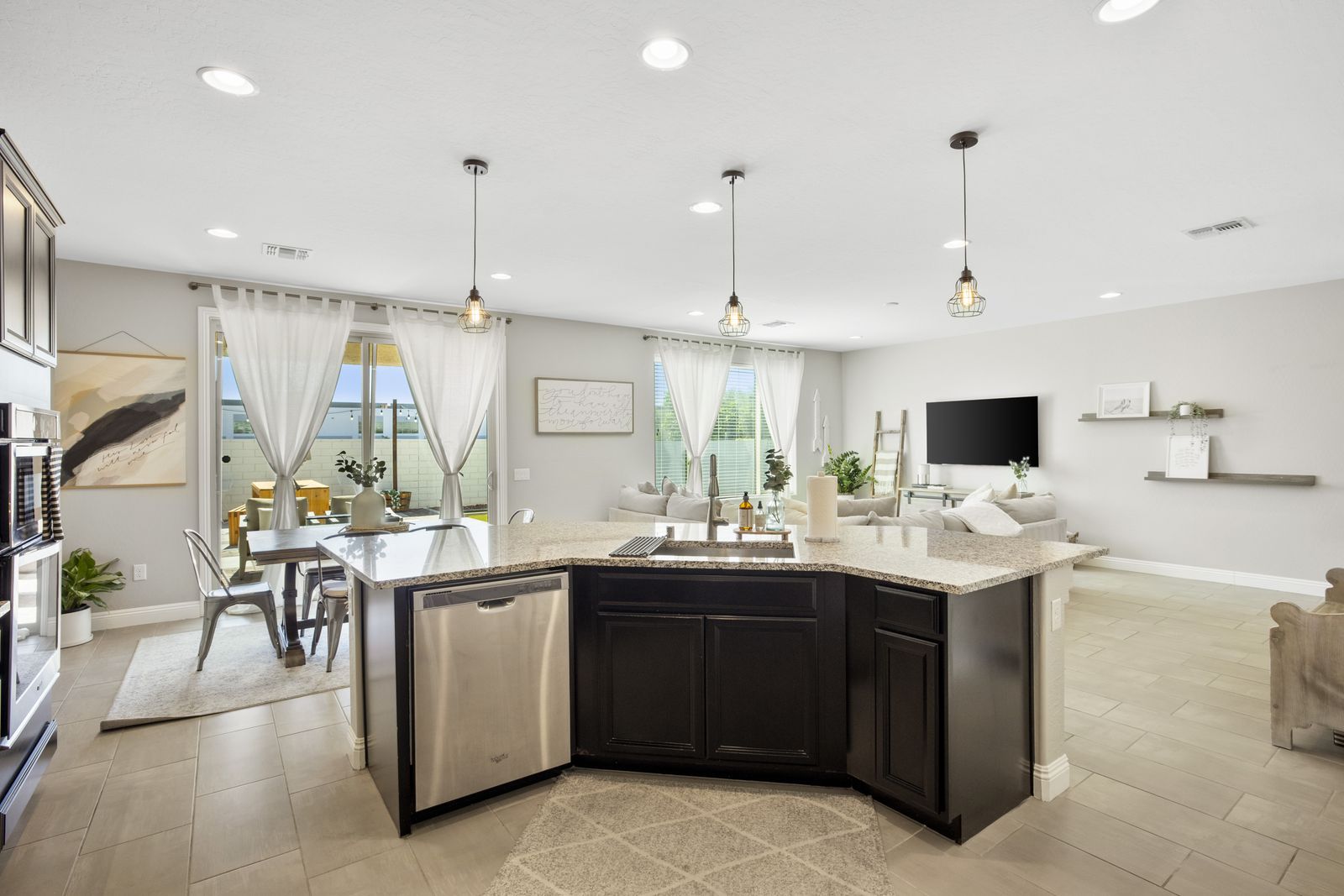 Kitchen island, dishwasher, and the slider out to the patio.