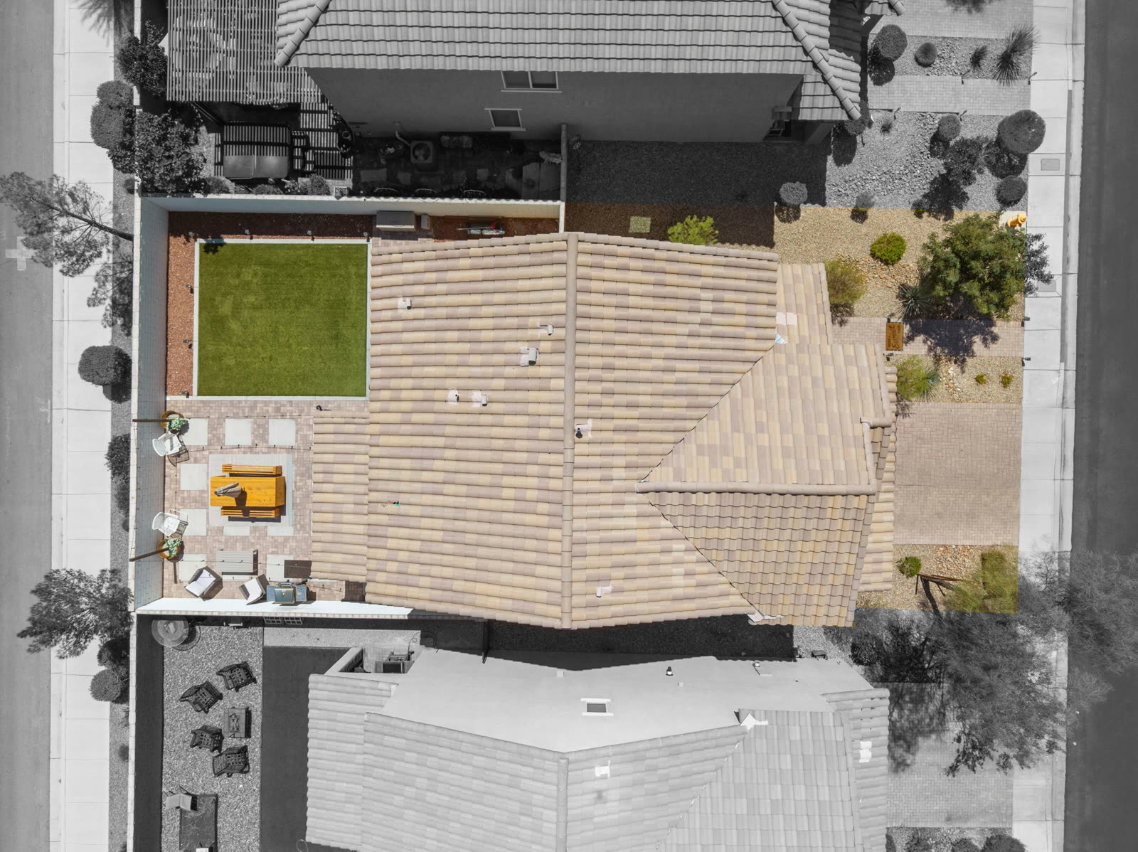 Straight down. The full lot: turf, paver patio, covered lounge, side yard and driveway.